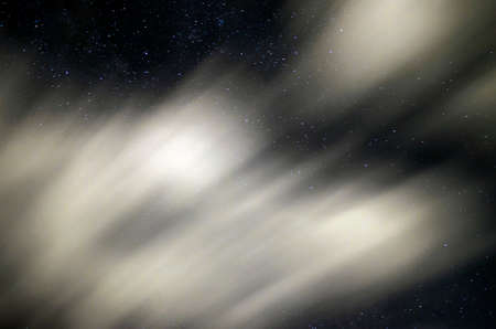 Sky in the night with stars and clouds blurry beccause they are in long exposure in summertimeの写真素材