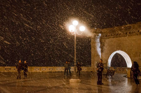 Cagliari, Italy - December 31: New Year night. Unidentified people under the snow and during the night in the upper square of the Bastion in Cagliari and called in italian Bastione on December 31.2014 in Caglari, Italy as editorialのeditorial素材