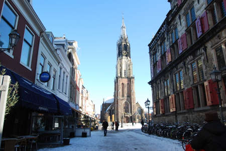 Delft, Netherlands - January 31: daily and snowy main square of Delft in the Netherlands in the morning with people and blue sky as lifestyle on January 31, 2010 in Delft, Netherlands as editorialのeditorial素材