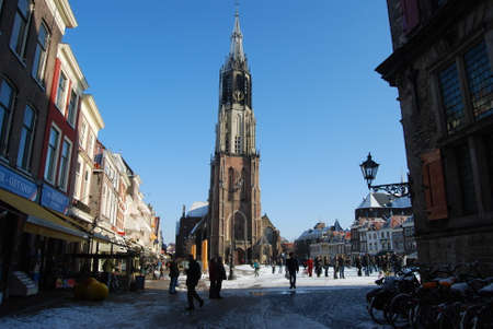 Delft, Netherlands - January 31: daily and snowy main square of Delft in the Netherlands in the morning with people and blue sky as lifestyle on January 31, 2010 in Delft, Netherlands as editorialのeditorial素材