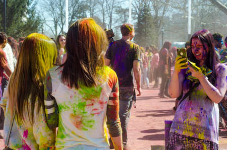 London Ontario, Canada - April 16:  Unidentified young colorful girls taking photos with the phone and having fun and celebrating at the Festival of Colours  on April 16.2016 in London Ontario, Canada as editorialのeditorial素材