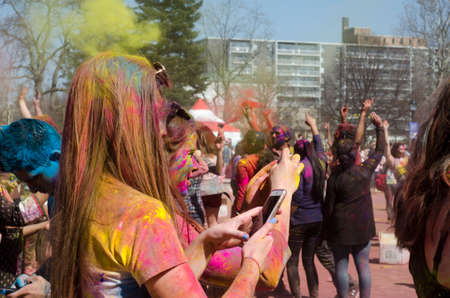 London Ontario, Canada - April 16:  Unidentified young colorful people having fun and celebrating at the Festival of Colours  on April 16.2016 in London Ontario, Canada as editorialのeditorial素材