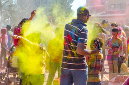 London Ontario, Canada - April 16: Unidentified young colorful people having fun and celebrating at the Festival of Colours on April 16.2016 in London Ontario, Canada as editorialのeditorial素材