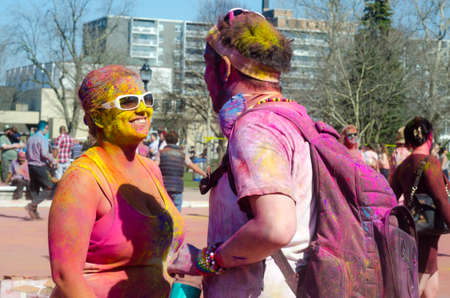 London Ontario, Canada - April 16: Portrait of two unidentified young guys  with a background of people having fun and celebrating the Festival of Colours on April 16.2016 in London Ontario, Canada as editorialのeditorial素材