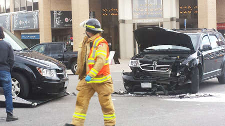 London Ontario, Canada - May 03, 2016: Firefighters respond to a two vehicle accident with one car destroyed in the middle of the street as editorialのeditorial素材