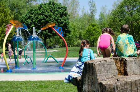 London Ontario, Canada - May 23, 2016:  Unidentified people in the city park and children playing in the aqua amusement park  area during summer  as editorialのeditorial素材