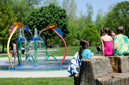 London Ontario, Canada - May 23, 2016:  Unidentified people in the city park and children playing in the aqua amusement park  area during summer  as editorialのeditorial素材
