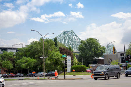 Montreal, Quebec, Canada - 18 July 2016 - Generic crossing and large streets in Montreal in summertime with Jacques-Cartier Bridge in the background. Modern style as editorialのeditorial素材
