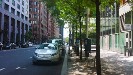 Montreal, Quebec, Canada - 20 July 2016: Electric cars charging at recharging station undert green trees in summertime as editorialのeditorial素材