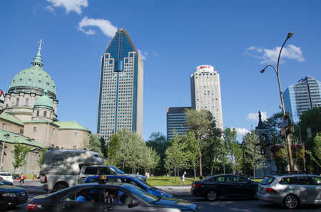 Montreal, Quebec, Canada - 18 July 2016 - Buildngs and heavy traffic in downtown in Montreal in summertime. Canadian lifestyle with cars, people and skyscapers as editorialのeditorial素材