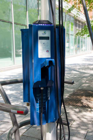 Montreal, Quebec, Canada - 20 July 2016: Recharging station for electric cars in the street under green trees in summertime as editorialのeditorial素材