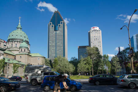 Montreal, Quebec, Canada - 18 July 2016 - Buildngs and heavy traffic in downtown in Montreal in summertime. Canadian lifestyle with cars, people and skyscapers as editorialのeditorial素材