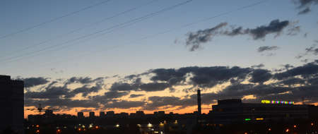 the outgoing sunset over the city houses