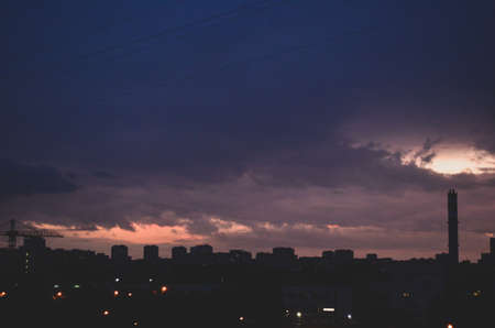 the outgoing sunset over the city housesの写真素材