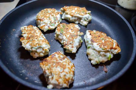 fried chicken mince patties with green on the blue iron pan top view