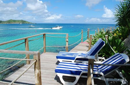 Beach chairs on a deckの写真素材