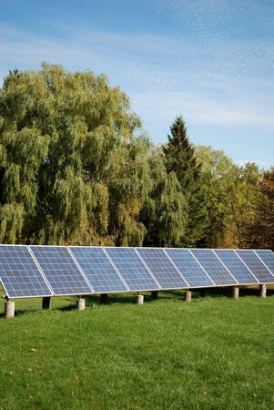 Sun energy batteries on green meadowの写真素材