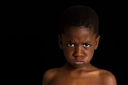 Small child's face showing emotion. One of a series of black and white images isolated on white.の写真素材
