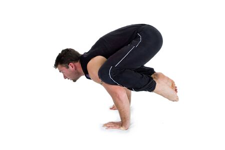 Young male gymnast practicing yoga.
