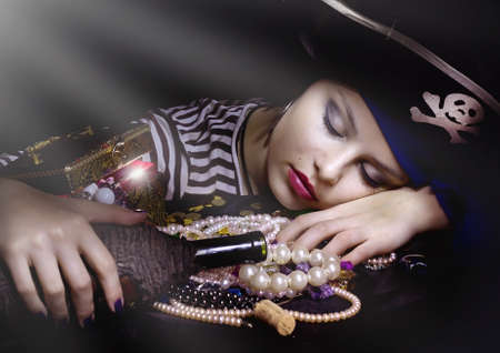 Woman pirate sleeping  with a bottle の写真素材