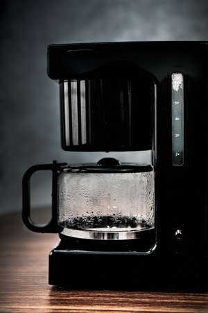 A man pouring coffee from a pot to a mug 3の写真素材