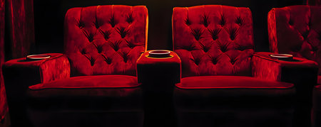 Comfortable red leather armchairs on a black background. 3d renderingの素材
