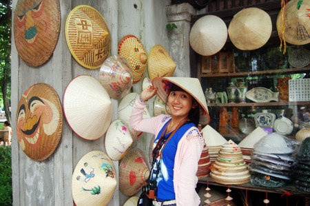 Traveler Thai Woman with conical Asian hat at Hanoi Vietnamの写真素材