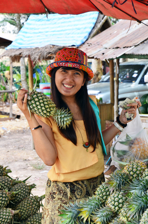 Women with  pineapple  Ananas comosusの写真素材