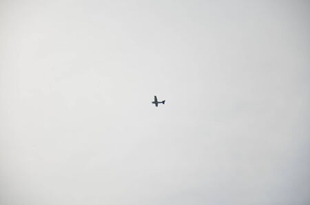 small plane in sky and white clouds in backgroundの写真素材