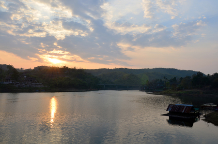Sunrise time at Saphan Mon Bridge - The 400m wooden bridge itself is well worth a visit and is the longest handmade wooden bridge in Sangkhlaburi Kanchanaburi Thailand.の写真素材