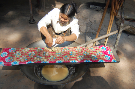 Cambodian people cooking Coconut sugar made from Asian Palmyra palm at siem reap market on April 14, 2009 in Siemreap, Cambodia.のeditorial素材
