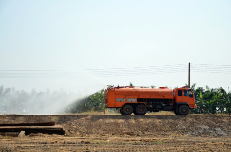 Water Truck spray to ground for protect occur dust at pond occur from excavation of the surface ground for Sale in Pathum Thani at Thailandの写真素材