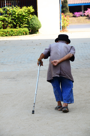 Old man walking at Wat Khua Khrae Temple in Chiang Rai, Thailand.の写真素材