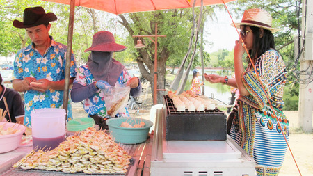 Thai woman buy Classic Banana on Toast at small market beside ayutthaya road on April 14, 2015 in Ayutthaya, Thailand.のeditorial素材