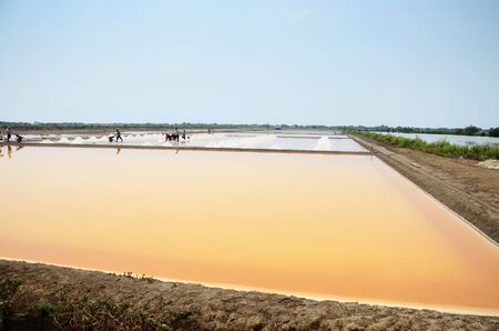 Thai people keeping salt from Salt farming or Salt evaporation pond to warehouse at Bangkhunthein on April 12, 2015 in Bangkok Thailand.のeditorial素材
