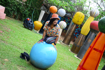 Thai woman playing in colorful playground at Tao Hong Tai Ceramics Factory on April 14, 2015 in Ratchaburi Thailand.のeditorial素材