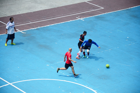 Thai men playing football or soccer on field at front of sport stadium on April 5, 2015 in Bangkok Thailandのeditorial素材