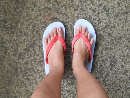 A pair of feet standing on the roadの写真素材