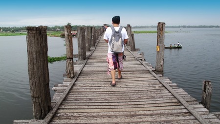 Thai man travel and walking at U Bein Bridge on May 19 2015 in Amarapura Myanmar.のeditorial素材