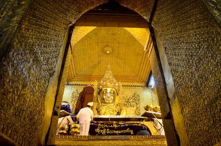 Ritual commences monks wash the face and brush the teeth of the  Mahamuni Buddha image in Mandalay Burma Myanmar.のeditorial素材