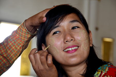 Burmese woman using tanaka makeup for traveler thai women at Atumashi monasteryの写真素材