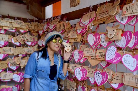 Thai woman with wood tag front of Kasuga Shrine on July 9, 2015 in Nara, Japanのeditorial素材
