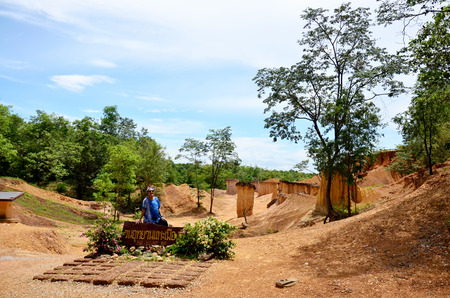 Thai woman portrait and happy feeling at Phae Mueang Phi of Pae Mueng Pee Royal Park in Phrae, Thailandの写真素材