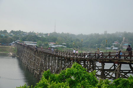 People travel and waiking on Saphan Mon wooden bridge in morning time at Sangkhlaburi on December 4, 2015 in Kanchanaburi, Thailand.のeditorial素材