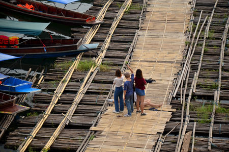 People travel and portrait on Antique bamboo bridge connecting the main part in morning time at Sangkhlaburi on December 4, 2015 in Kanchanaburi, Thailand.のeditorial素材