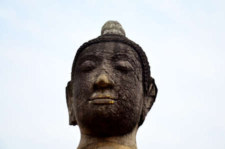 Broken buddha statue and ancient building at Wat Mahathat in Ayutthaya, Thailand