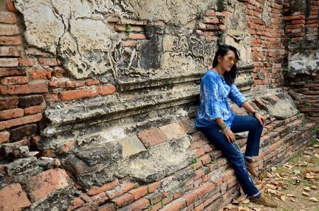 Thai woman portrait at ancient building at Wat Mahathat in Ayutthaya, Thailandの写真素材