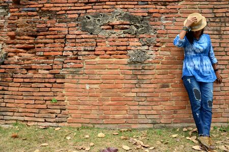 Thai woman portrait at ancient building at Wat Mahathat in Ayutthaya, Thailandの写真素材