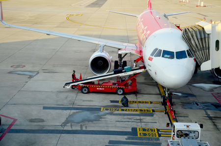 Thai people loading baggage to store room of plane for flight at Don Mueang international airport on January 21, 2016 in Bangkok, Thailandのeditorial素材