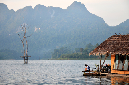 People sitting at raft resort at Khao Sok National Park on March 3, 2011 in Surat Thani, Thailandのeditorial素材